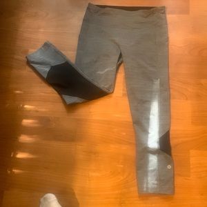 Lululemon leggings.  Grey with black.  Logo on leg by calf.